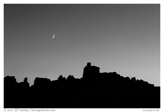 Crescent moon at sunset and Doll House spires. Canyonlands National Park (black and white)