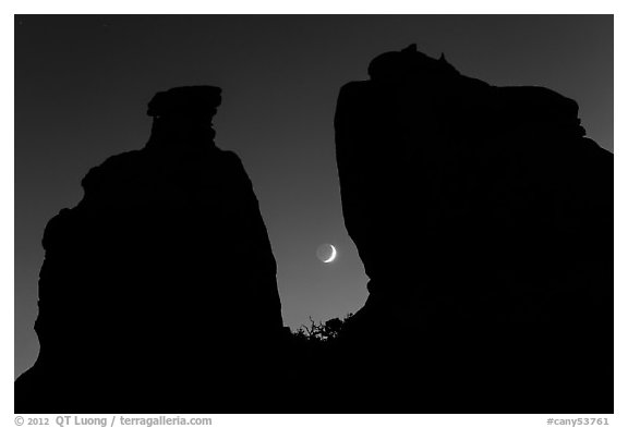 Crescent moon framed by Dollhouse spires. Canyonlands National Park (black and white)