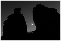 Crescent moon framed by Dollhouse spires. Canyonlands National Park ( black and white)