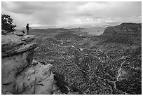 Park visitor looking, Wingate Cliffs at Flint Trail overlook. Canyonlands National Park ( black and white)