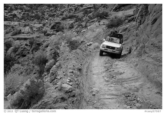 High clearance four-wheel-drive vehicle on the Flint Trail,  Orange Cliffs Unit,  Glen Canyon National Recreation Area, Utah. USA (black and white)