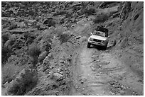 High clearance four-wheel-drive vehicle on the Flint Trail,  Orange Cliffs Unit,  Glen Canyon National Recreation Area, Utah. USA ( black and white)