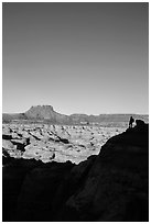 Hiker standing in silhouette above the Maze. Canyonlands National Park ( black and white)