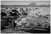 Group hiking down into the Maze. Canyonlands National Park ( black and white)