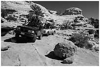 Vehicles on ledge in Teapot Canyon. Canyonlands National Park, Utah, USA. (black and white)