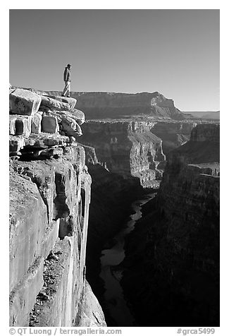 Man standing at  edge of  Grand Canyon at Toroweap, early morning. Grand Canyon National Park (black and white)