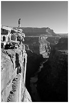 Man standing at  edge of  Grand Canyon at Toroweap, early morning. Grand Canyon National Park, Arizona, USA. (black and white)