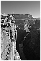 Visitor sitting on  edge of  Grand Canyon, Toroweap. Grand Canyon National Park, Arizona, USA. (black and white)