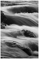 Boulders and rapids with warm light from canyon walls reflected. Grand Canyon National Park ( black and white)