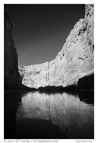 Steep limestone canyon walls reflected in Colorado River, early morning. Grand Canyon National Park (black and white)