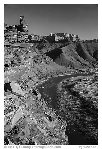 Photographer on sheer cliff above Unkar rapids. Grand Canyon National Park (black and white)