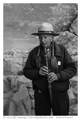Native American Ranger plays flute to honor ancestors. Mesa Verde National Park (black and white)