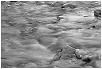 Water flowing in the Virgin River, with reflections from cliffs. Zion National Park, Utah, USA. (black and white)