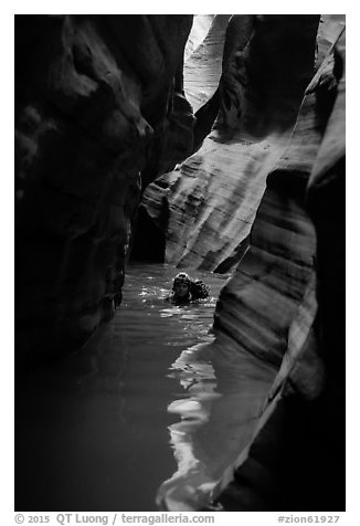 Canyoneer in dark flooded Pine Creek Canyon. Zion National Park (black and white)
