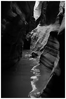Canyoneer in dark flooded Pine Creek Canyon. Zion National Park ( black and white)