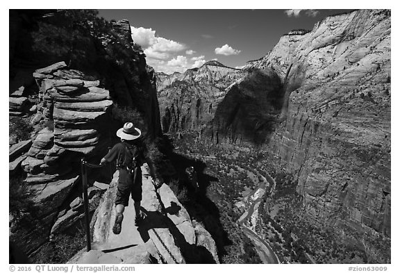Hiker stepping next to sheer cliff, Angels Landing. Zion National Park (black and white)