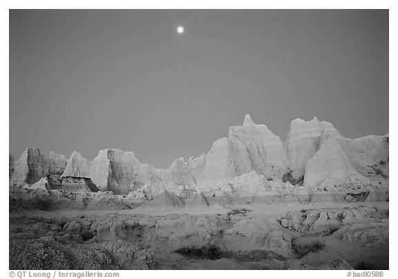 Moon and eroded badlands, Cedar Pass, dawn. Badlands National Park (black and white)