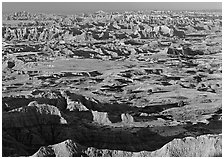 Prairie and eroded ridges stretching to horizon, early morning. Badlands National Park ( black and white)