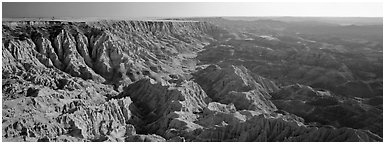 Badlands carved into prairie by erosion, Stronghold Unit. Badlands National Park (Panoramic black and white)