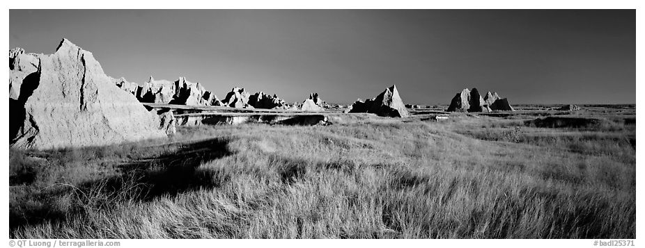 Badlands raising in tall grass prairie landscape, Cedar Pass. Badlands National Park (black and white)