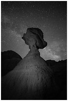 Balanced rock at night with starry sky and Milky Way. Badlands National Park, South Dakota, USA. (black and white)