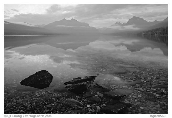 Rocks, peebles, and mountain reflections in lake McDonald. Glacier National Park (black and white)