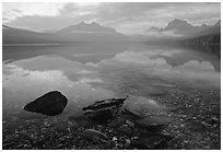 Rocks, peebles, and mountain reflections in lake McDonald. Glacier National Park, Montana, USA. (black and white)