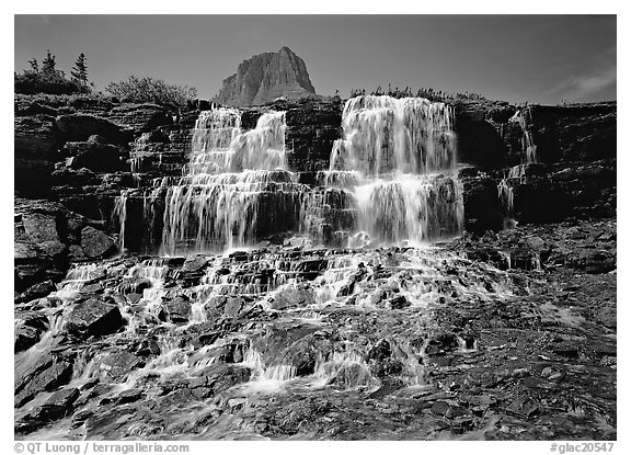 Waterfall at hanging gardens, with top of Mountain. Glacier National Park (black and white)