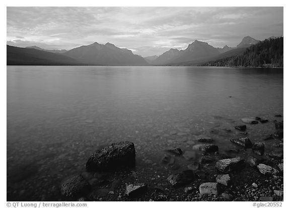Rocks, Lake Mc Donald, and mountains at sunset. Glacier National Park (black and white)