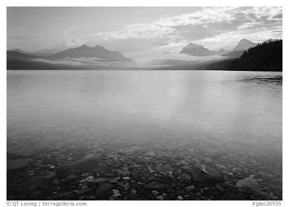 Lake McDonald with clouds and mountains reflected in early morning. Glacier National Park (black and white)