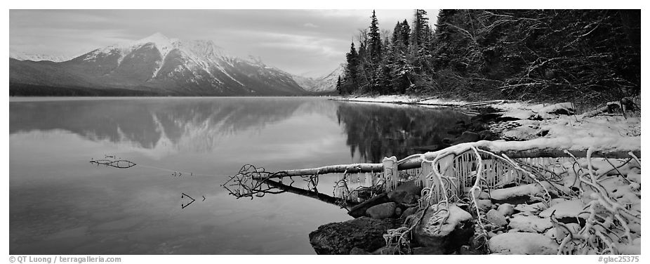 Lake, snowy shore, and mountains in winter. Glacier National Park (black and white)
