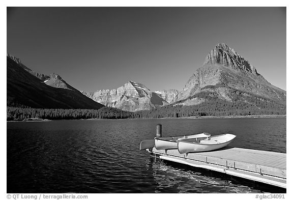 Deck and small boats on Swiftcurrent Lake. Glacier National Park (black and white)