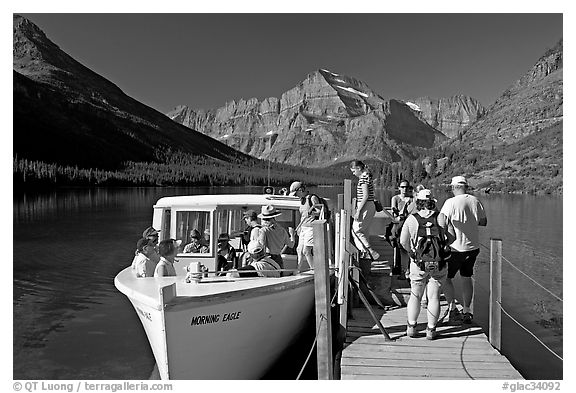 Passengers embarking on tour boat at the end of Lake Josephine. Glacier National Park (black and white)