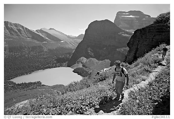 Hikers on trail overlooking Grinnell Lake. Glacier National Park (black and white)