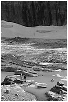 Crossing the outlet stream of the Grinnell glacial lake. Glacier National Park ( black and white)