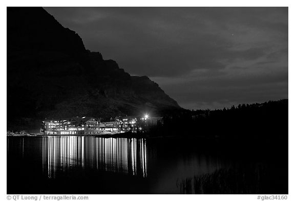 Many Glacier lodge lights reflected in Swiftcurrent Lake at night. Glacier National Park (black and white)