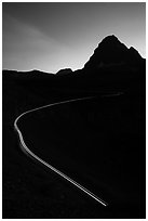 Going-to-the-Sun road at dusk with car light trail. Glacier National Park ( black and white)