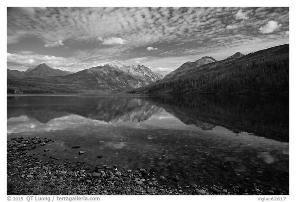 Shoreline with pebbles and mountains with reflections, Kintla Lake. Glacier National Park (black and white)