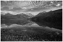 Shoreline with pebbles and mountains with reflections, Kintla Lake. Glacier National Park ( black and white)