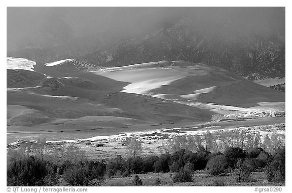 Storm light illuminates portions of the dune field. Great Sand Dunes National Park and Preserve (black and white)