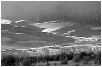 Storm light illuminates portions of the dune field. Great Sand Dunes National Park and Preserve ( black and white)