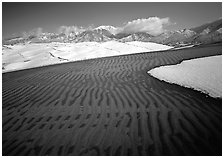 Ripples in partly snow-covered sand dunes. Great Sand Dunes National Park, Colorado, USA. (black and white)