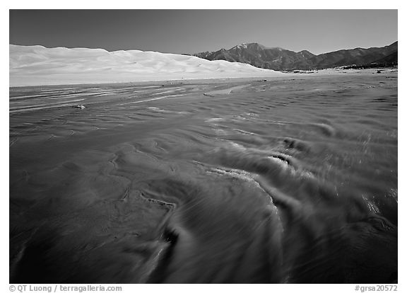 Medano creek with shifting sands, dunes and Sangre de Christo mountains. Great Sand Dunes National Park and Preserve (black and white)