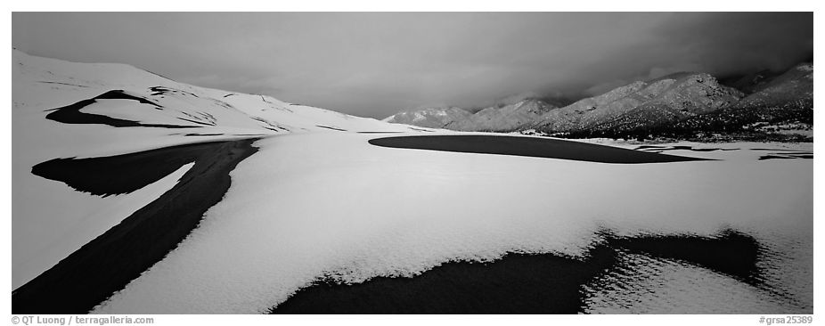 Snow-covered dune landscape and mountains at dawn. Great Sand Dunes National Park and Preserve (black and white)