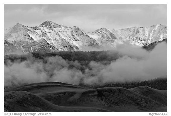 Snowy Sangre de Cristo Mountains and clouds above dune field. Great Sand Dunes National Park and Preserve (black and white)