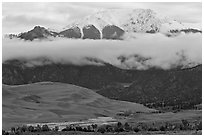 Dunes and Medano creek below snowy mountains. Great Sand Dunes National Park, Colorado, USA. (black and white)