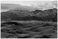 Dunes and mountains with fall colors at dusk. Great Sand Dunes National Park, Colorado, USA. (black and white)