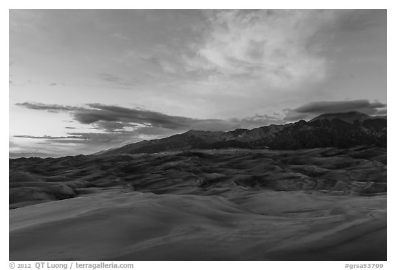 Dune field and Sangre de Cristo mountains with cloud lighted by sunset. Great Sand Dunes National Park and Preserve (black and white)