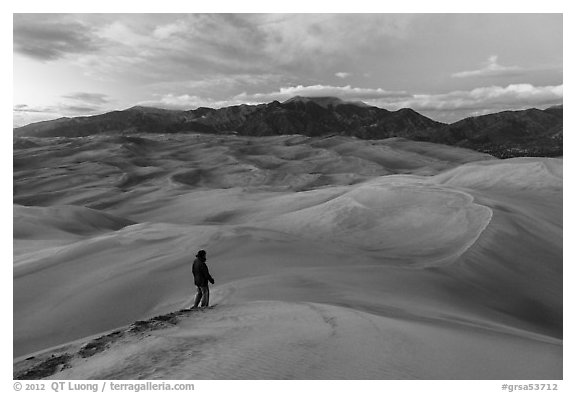 Visitor looking, dune field. Great Sand Dunes National Park and Preserve (black and white)