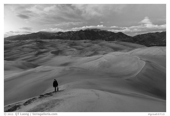 Hiker climbing high dune. Great Sand Dunes National Park and Preserve (black and white)